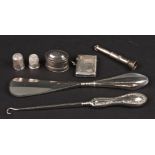 A small collection of assorted silver comprising a silver nutmeg grater, vesta, button hook and shoe