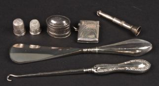 A small collection of assorted silver comprising a silver nutmeg grater, vesta, button hook and shoe