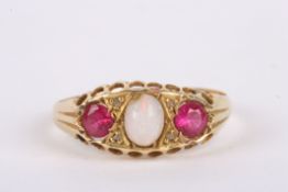 A three stone opal and pink gem set gypsy ring, with pierced 18ct gold mount and diamond point