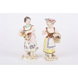 Two 20th century Meissen porcelain figures of flower girls both holding flowers and supported on