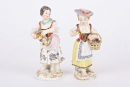 Two 20th century Meissen porcelain figures of flower girls both holding flowers and supported on