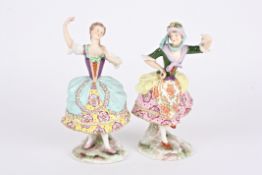 A pair of porcelain figures of dancing girls 'Asselin' and 'Pitrot', both wearing floral dresses and