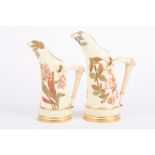 A pair of Royal Worcester ivory ground graduated tusk jugs decorated with flowers and with bark