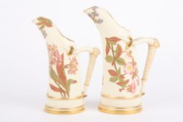 A pair of Royal Worcester ivory ground graduated tusk jugs decorated with flowers and with bark