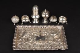 A collection of silver and silver plated cruets including two silver pepperettes, a pair of silver