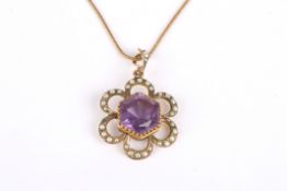 An Edwardian 9ct gold amethyst and seed pearl pendant the hexagonal amethyst surrounded by seed