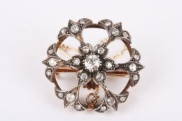A Victorian diamond set circular cluster brooch/pendant the central diamond cluster of floral design