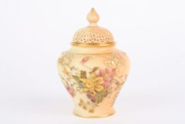 A Royal Worcester blush ivory potpourri vase decorated with flowers, numbered H279 to the base. 13cm