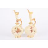 A pair of Royal Worcester ivory ground bottle jugs with slender necks and globular bodies, decorated