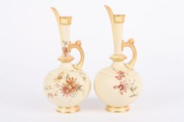 A pair of Royal Worcester ivory ground bottle jugs with slender necks and globular bodies, decorated