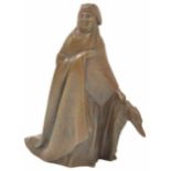 A bronzed figure of a lady wearing a full length cloak and tri-form hat, holding a standing