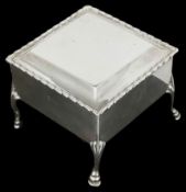 A silver trinket box of square form with silver gilt interior lid, and velvet lined interior, raised