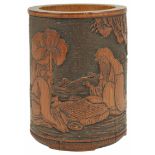 A 19th century Chinese carved bamboo brush pot carved with a scene of two seated figures playing Go,