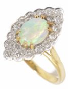 An opal and diamond marquis shaped cluster ring the central oval opal within a fancy edged