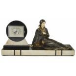 A 1930s Art Deco mantel clock decorated with a reclining lady with ivorine face and hands, the clock