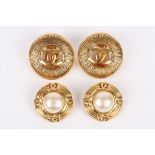 A pair of Chanel vintage clip earrings with large central pearl within a Chanel logo frame. Spring