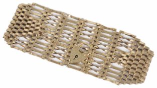 A mid 20th Century 9ct gold twelve bar gate bracelet with heart padlock fastening Approx. weight 23
