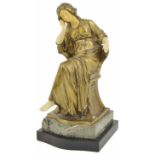 A gilt metal seated lady early 20th century, seated wearing a flowing dress, with ivorine hands,