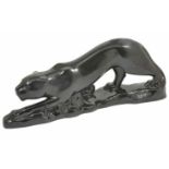 A large Art Deco style pottery black panther modelled in stalking pose on shaped naturalistic base,