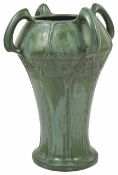 An Amphora Art Noveau four handled pottery vase the waisted body decorated with stylised tree and