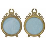 A pair of gilt metal Continental photo frames of circular form, raised on ball feet, with ribbon and