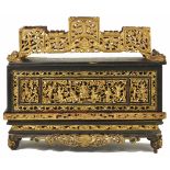 A 19th century Chinese carved gilt and lacquered sectioned display stand/ancestar box the front well