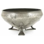 A Liberty Tudric pewter bowl with inverted rim, raised on three stylised feet, stamped on the
