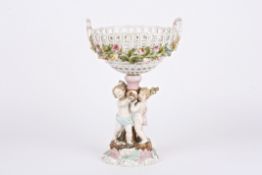 A 19th century Continental porcelain table centrepiece basket held aloft by three cherubs holding