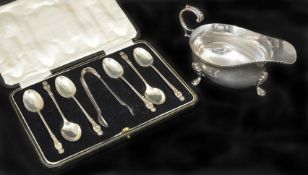 A silver sauce boat hallmarked London 1935, together with a cased set of apostle spoons and