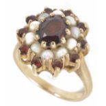 A garnet and opal set oval cluster ring, the central garnet within an opal cluster and outer