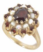 A garnet and opal set oval cluster ring, the central garnet within an opal cluster and outer