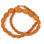 A butterscotch amber necklace of graduated beads weight approx. 68 gm. Largest bead measures 3.2