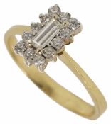 A contemporary baguette diamond cluster ring, the central baguette cut diamond surrounded by small