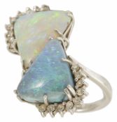 An unusual large precious opal and diamond double cluster ring, circa 1970, set with opposing 'light