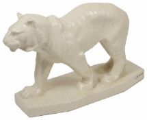 An Art Deco style pottery tiger crackle glaze modelled standing on a rectangular base signed LEJAN.