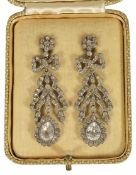 A pair of early 20th century paste set ribbon drop earrings with bow tops and pear shaped cluster