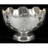 An Edwardian silver rose bowl hallmarked Sheffield 1909, with fluted rim and embossed scroll