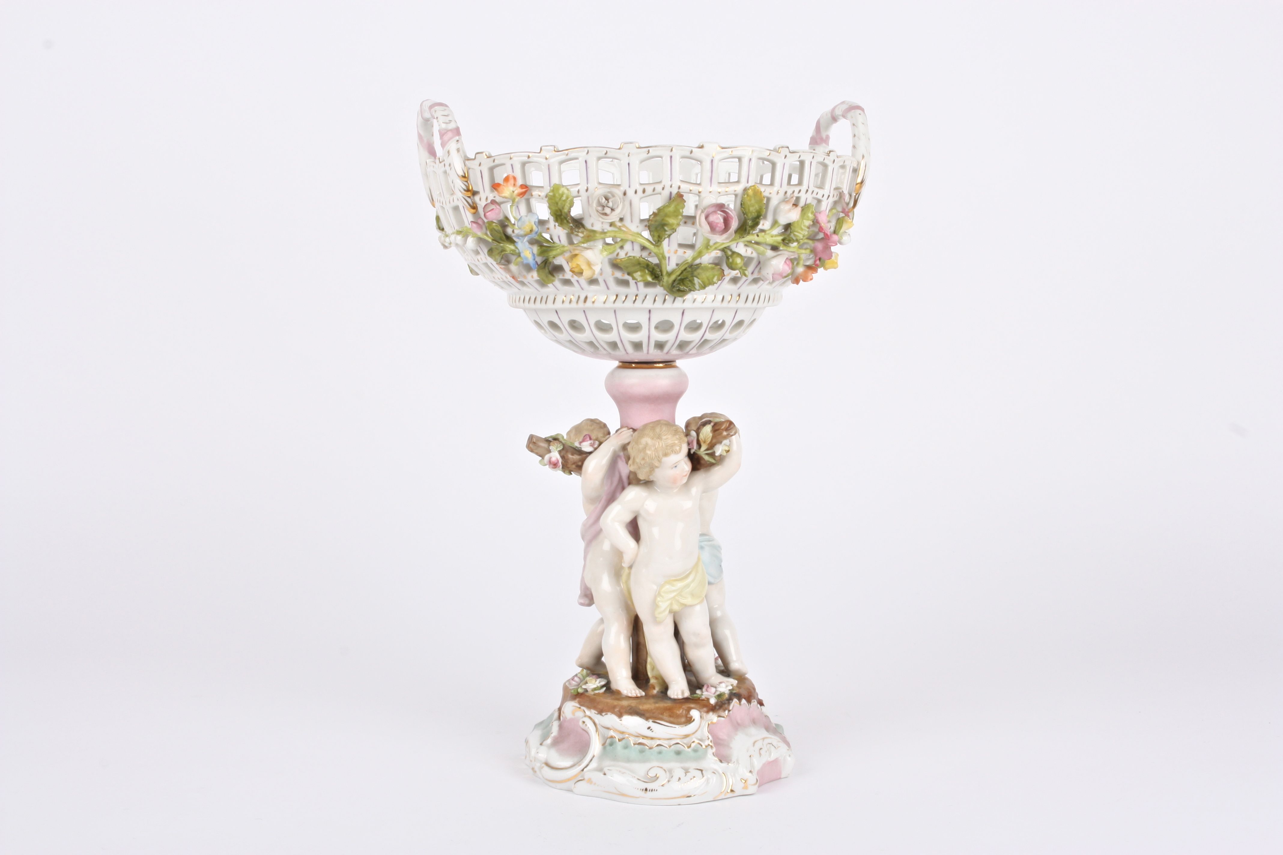 A 19th century Continental porcelain table centrepiece basket held aloft by three cherubs holding - Image 2 of 3