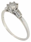 A platinum mounted diamond ring with central brilliant of approximately 0.50 in weight flanked on