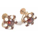 A pair of 9ct gold garnet and pearl set circular cluster earrings with central garnet with