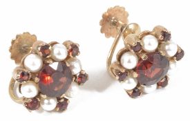 A pair of 9ct gold garnet and pearl set circular cluster earrings with central garnet with