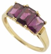 A continental three stone rectangular cut amethyst ring in 9K marked mount, in associated box.