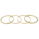 A pair of Continental .750 heavy narrow bangles with sectioned rope twist design, together with