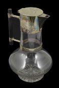 A silver plated and glass claret jug attributed to Christopher Dresser of typical form with