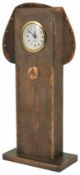 A Continental Art Nouveau copper timepiece the hammered rectangular body with central stylised