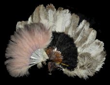 A collection of three 1930's feather fans largest fan with cream and brown ostrich feathers and