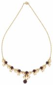 A contemporary 9ct gold garnet and pearl set drop necklace of seasonal stylised foliate scroll