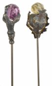 Two Edwardian hat pins the first with silvered metal thistle supporting faceted citrine and