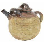 A large pottery teapot with streaked brown glaze to lid and spout, stamped on the