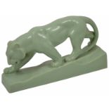 An Art Deco style green glazed tiger in walking pose raised on a base, no marks. length 35cm